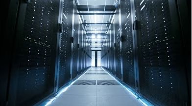 A wide-angle view of a high-tech data center corridor lined with server racks on both sides.