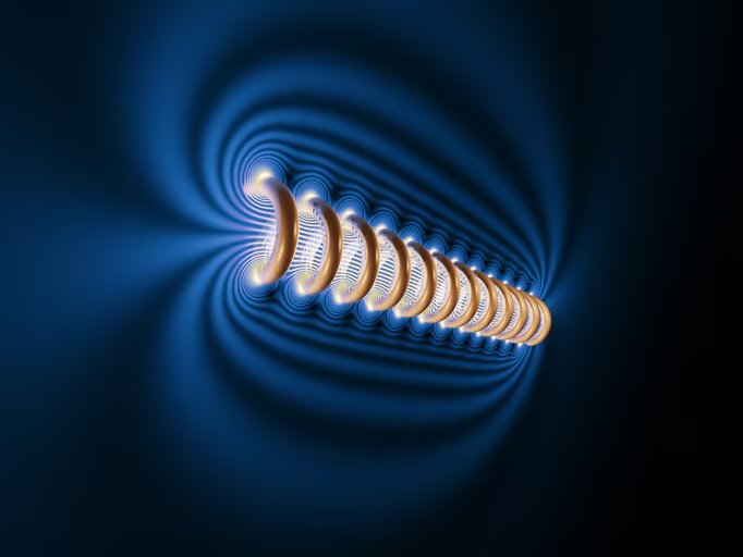 This image features a stylized representation of electromagnetic field lines surrounding a cylindrical object. The setting is abstract and digital, with glowing blue and gold hues creating a sense of energy and motion. The visual effect highlights the flow and intensity of the field.