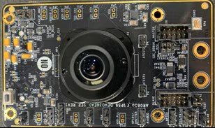 This image shows a detailed view of an electronic camera module circuit board. 