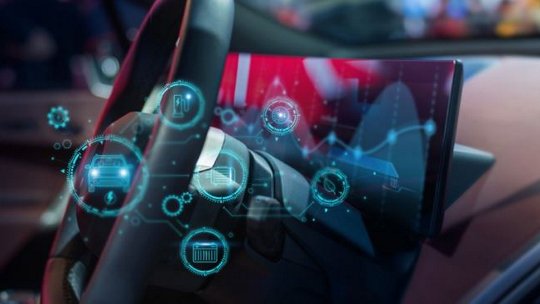 A modern car interior features a close-up view of the steering wheel and dashboard, enhanced by a transparent digital interface overlay. 