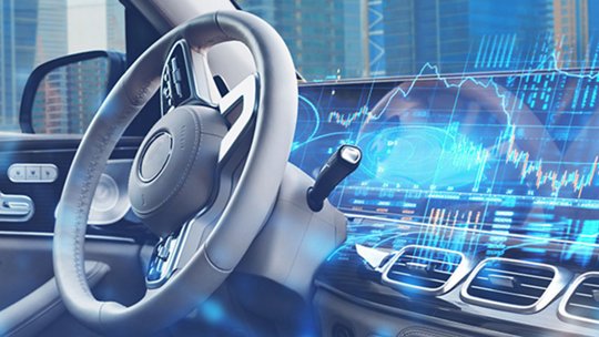 A modern car interior is shown with a focus on the steering wheel and dashboard. 