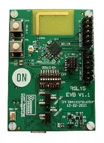 Green circuit board with numerous electronic components, including switches, LEDs, and connectors, displaying the RSL15 EVD V1.1 description.