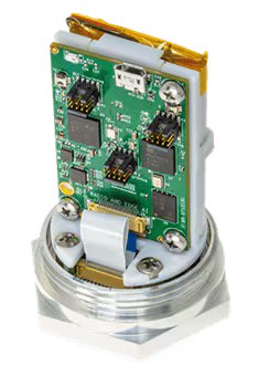 A close-up view of an exposed electronic circuit board mounted within a metallic industrial sensor housing. The image highlights various microchips, connectors, and wiring on the green PCB.