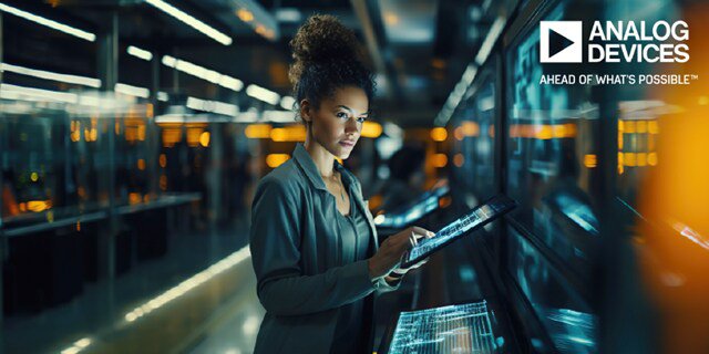 A woman stands in a modern, high-tech environment, interacting with a large touchscreen display. The setting features illuminated panels and reflective surfaces. The 'ANALOG DEVICES' logo and the phrase 'AHEAD OF WHAT'S POSSIBLE' are clearly visible in the upper right corner.