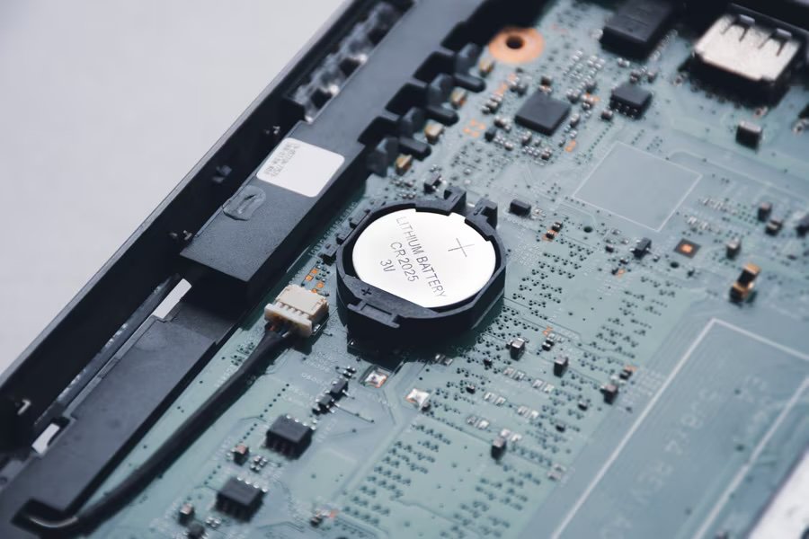 A detailed view of an electronic circuit board featuring a visible coin cell battery labeled 'CR2032 3V'.