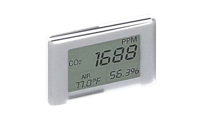 A digital air quality monitor is shown with a clear LCD screen displaying CO2 concentration at 1688 PPM. The device also shows air temperature at 77.0°F and humidity at 56.3%. The monitor is housed in a sleek, silver rectangular casing.