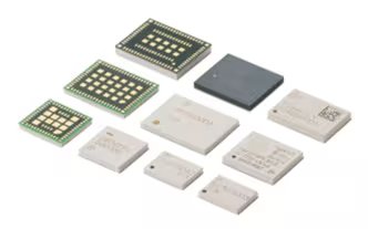 A collection of various electronic microchips and circuit modules is arranged on a plain white background. The chips vary in size, shape, and color, with some showing visible gold contact points and others featuring printed codes or QR patterns.