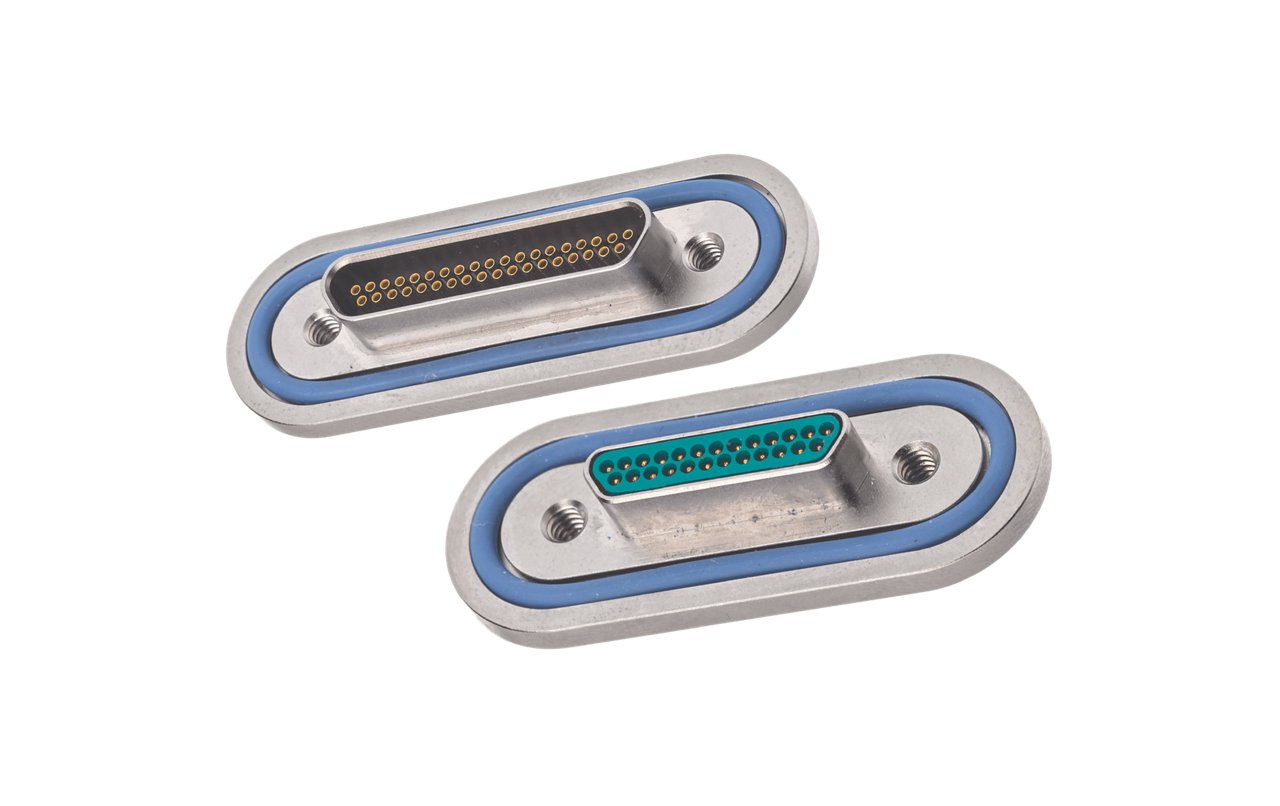 The image shows two oval-shaped multi-pin electrical connectors, each with a metallic casing and blue gasket. One connector features a dense array of gold pins, while the other has a grid of green sockets. Both connectors are displayed against a solid black background, highlighting their industrial design and precision engineering.