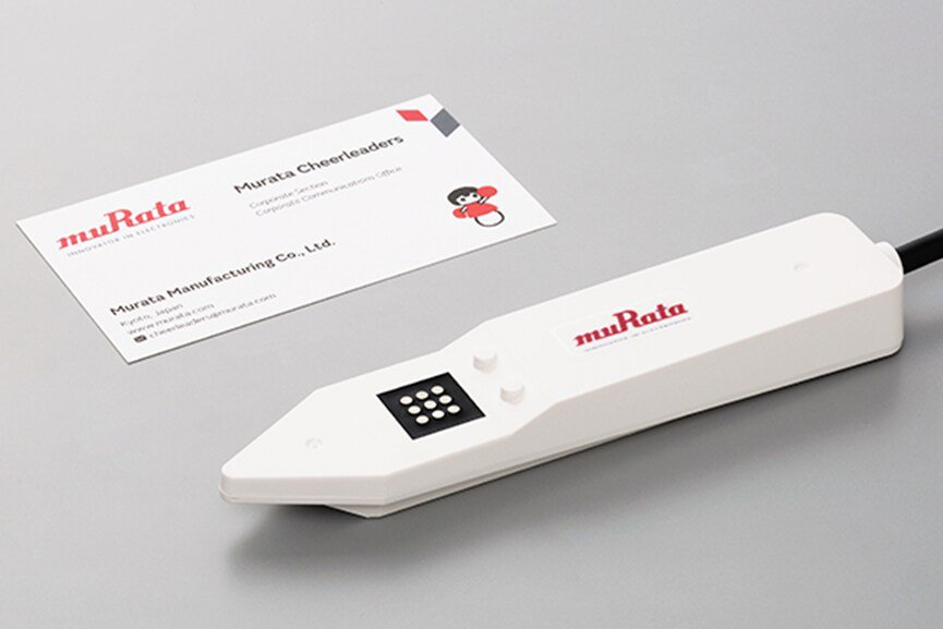 Murata soil sensor with Murata business card on desk