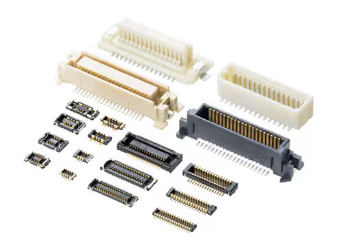 A collection of electronic connectors is displayed, featuring multiple sizes and configurations. The connectors are arranged on a white background, showcasing both male and female types with visible gold-plated pins. The components are primarily plastic and metal, in shades of white, beige, and black.