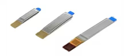The image shows three metallic test strips arranged side by side on a white background. Each strip has a colored end, with two featuring blue and gold, and one with blue and brown.