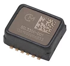 Close-up image of an SCL3300-D01 electronic sensor chip, featuring a rectangular black casing with gold connector pins.