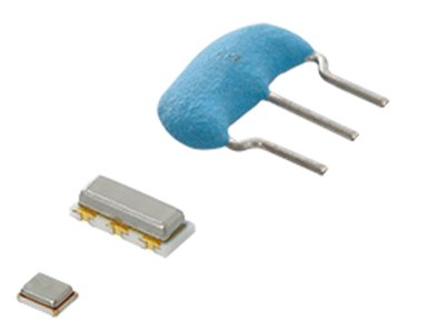 The image shows a small group of electronic components isolated on a white background. A larger blue, two-leaded component is positioned at the top, with two smaller metallic components below it. The parts appear to be precision electronic devices used in circuits or boards. The clean, minimal presentation emphasizes their shapes and materials.
