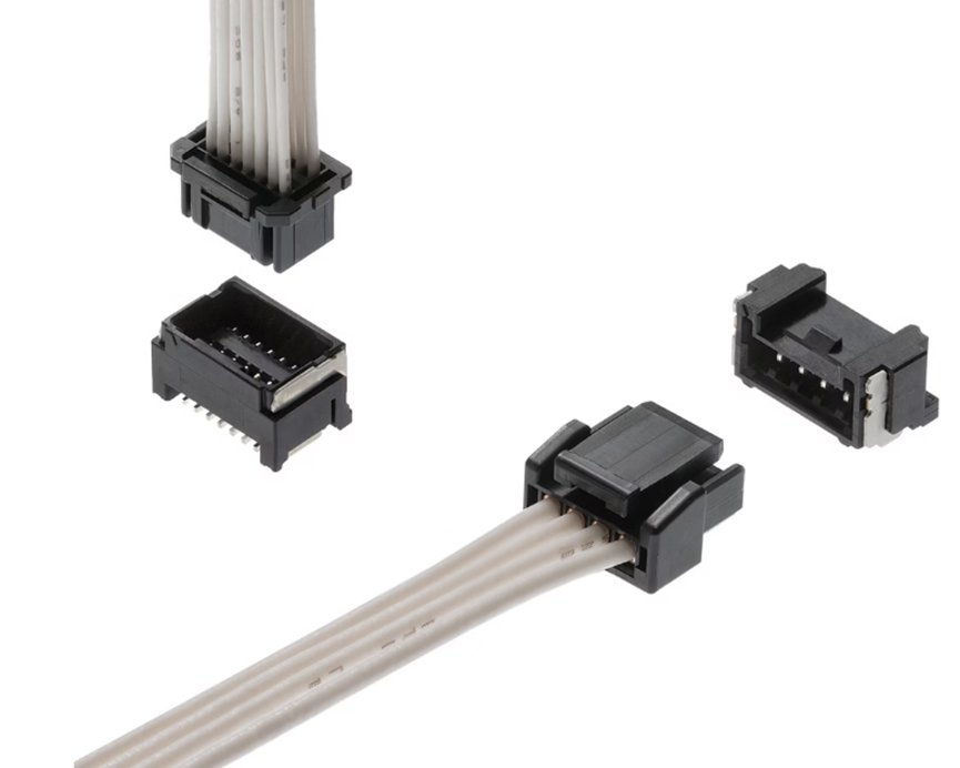 Image shows several small black electrical connectors attached to and separated from a flat ribbon cable. The components are displayed against a clean white background, highlighting their structure and contact pins. Different connector orientations reveal the internal terminals and housing details. The scene emphasizes electronic hardware used for wiring and circuit connections.
