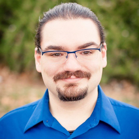 Portrait headshot of author Nick Powers