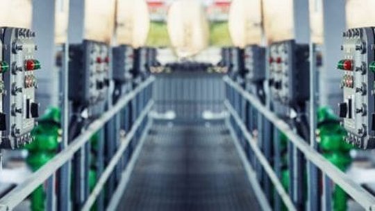 A symmetrical view of industrial control panels in a factory environment