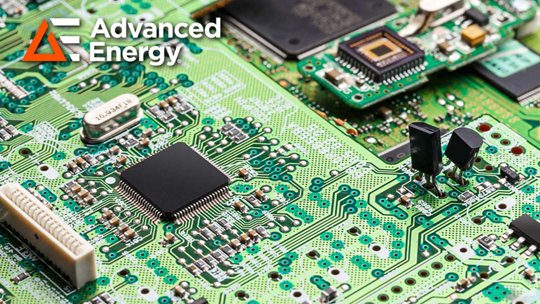 Close-up view of a green printed circuit board populated with integrated circuits and electronic components
