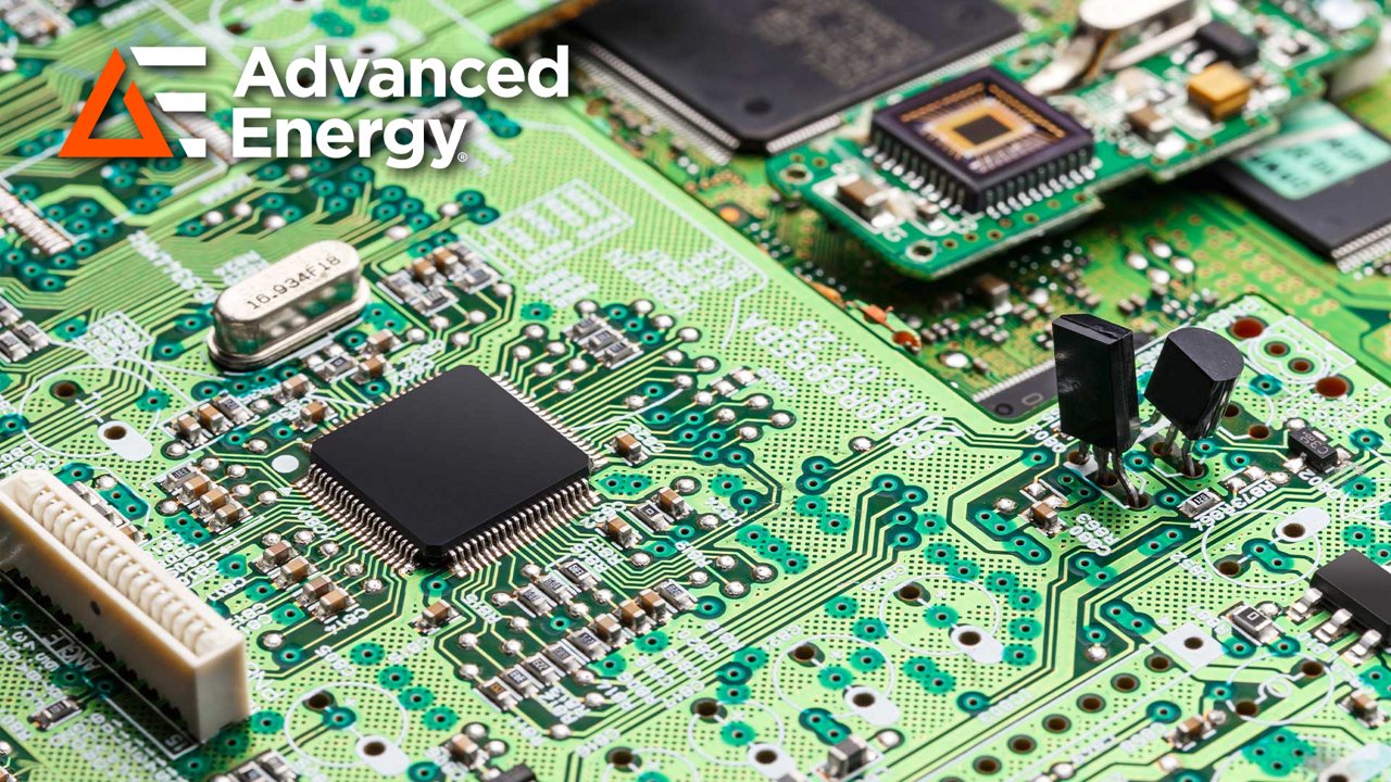Close-up view of a green printed circuit board populated with integrated circuits and electronic components