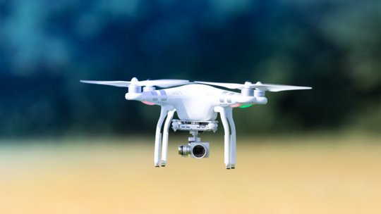 Image of white drone flying in outdoor setting