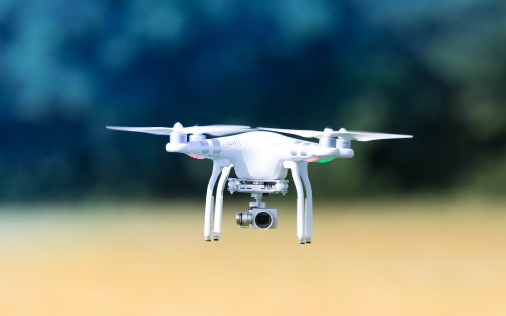 Image of white drone flying in outdoor setting