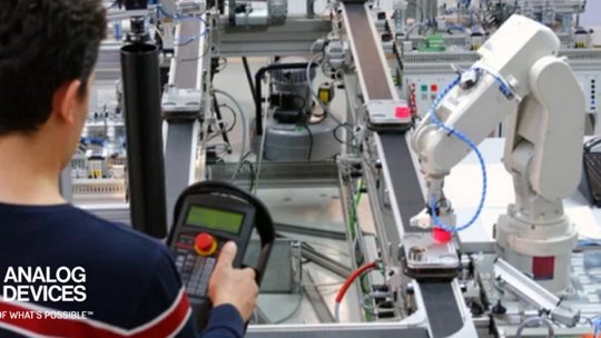 Man programming robotic arm in laboratory