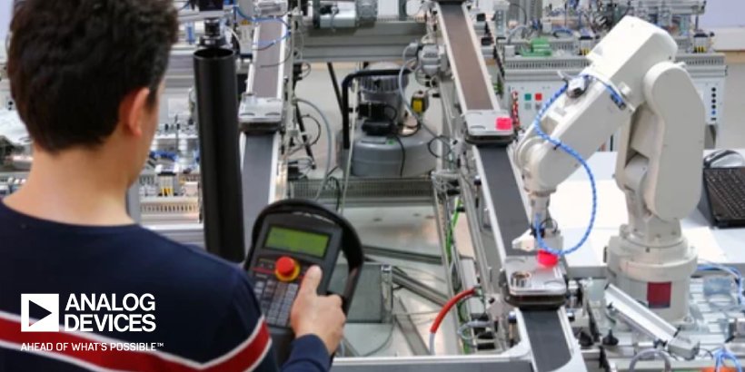 Man programming robotic arm. Analog Devices logo present in lower left-hand corner