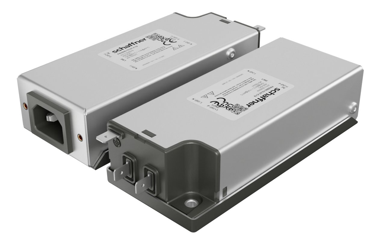 Two rectangular metal electrical filter modules are shown on a plain background. One unit is positioned to display its power inlet side, while the other reveals terminal connections and mounting base. Both devices feature printed specification labels with technical symbols and certification marks. The overall appearance is clean, industrial, and functional, emphasizing precision engineering and durable construction.