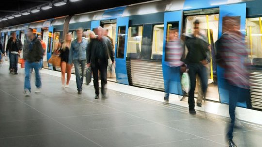 Image of bustling subway terminal blur of people walking around