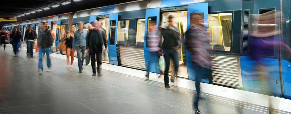Image of bustling subway terminal blur of people walking around