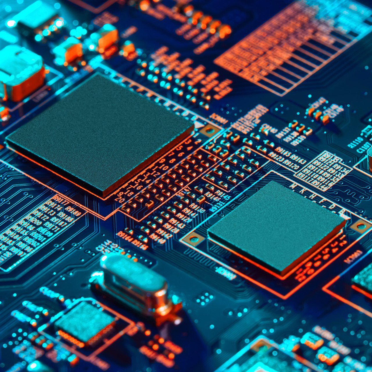 Macro view of a computer circuit board shows several large integrated chips and detailed electronic traces.