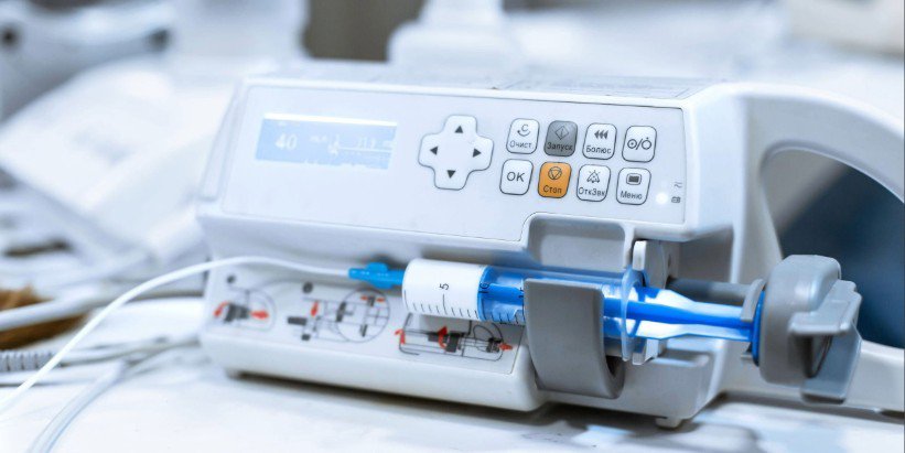 A close-up view of a medical infusion pump featuring a syringe securely attached.