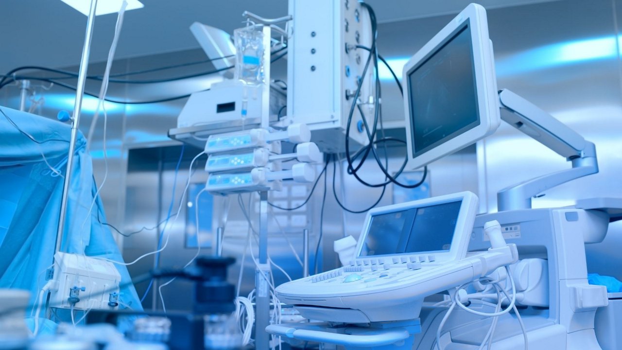 Advanced medical devices and monitors are displayed in a clean, sterile hospital environment.