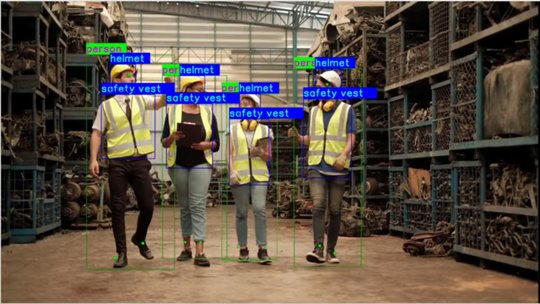 Four workers walk through an industrial warehouse aisle filled with stacked metal parts