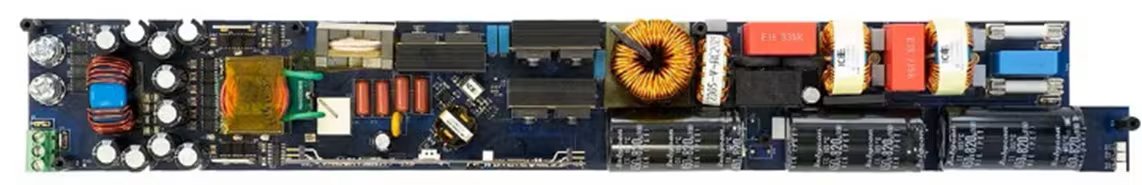 A close-up image of a rectangular electronic circuit board featuring various components such as capacitors, coils, resistors, and transformers. The board is photographed from above, showcasing the intricate arrangement of parts and wiring.