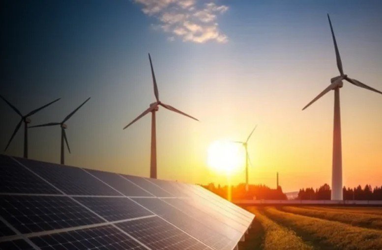 The image features a field of solar panels in the foreground and several wind turbines in the background.