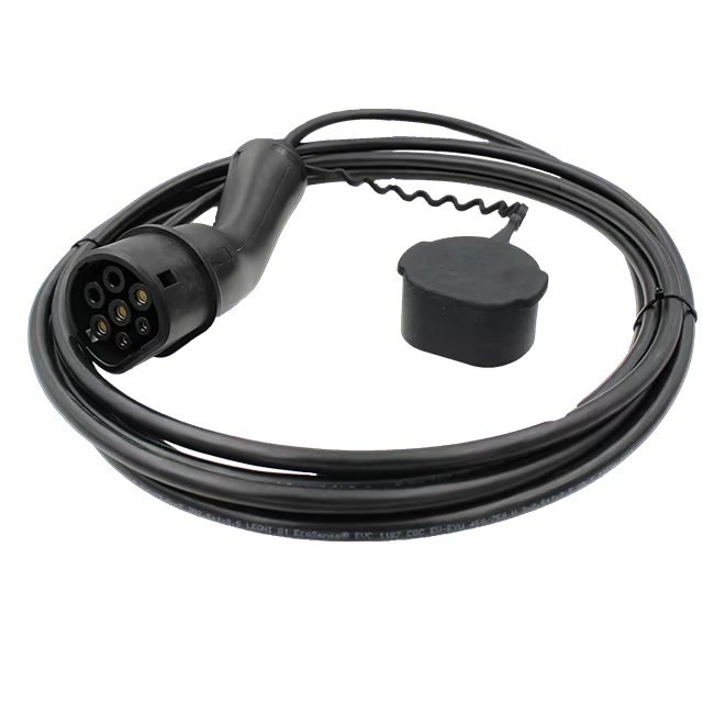 A coiled black electric vehicle charging cable. The cable features a multi-pin connector at one end and a protective cap attached by a flexible cord.
