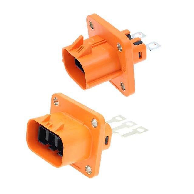 Two orange high-voltage electrical connectors. The connectors feature a rectangular housing with mounting flanges and three metal prongs for electrical connection.