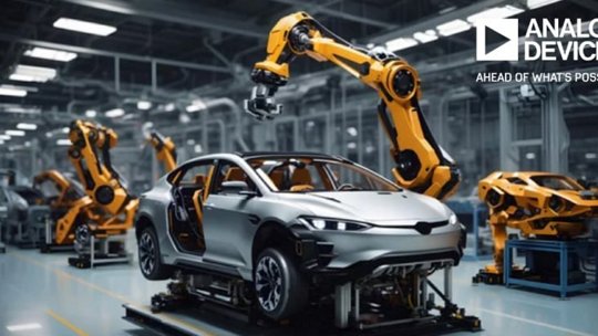 A sleek silver car is being assembled in a modern factory setting using advanced robotic arms