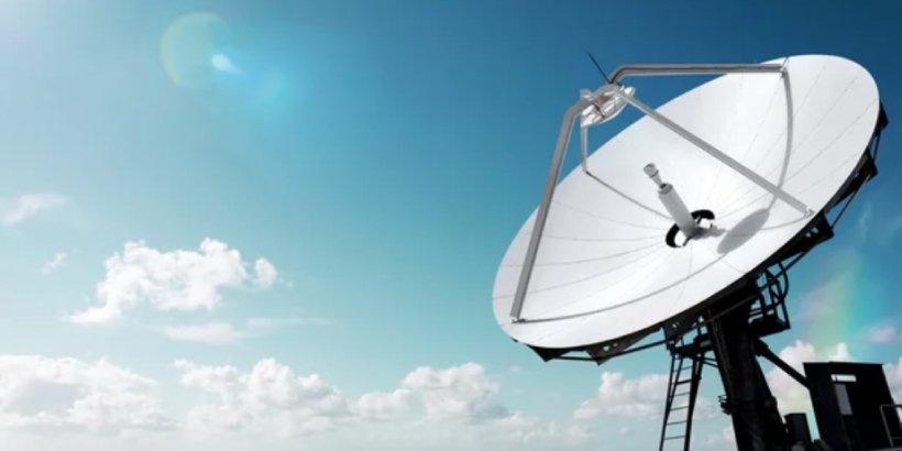 A large white satellite dish is positioned against a bright blue sky with scattered clouds.