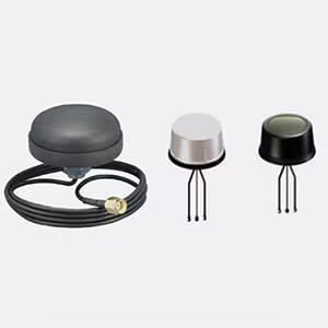 Three compact electronic sensors, each with a distinct design. One sensor is attached to a coiled cable with a visible connector, while the other two have three exposed prongs each.