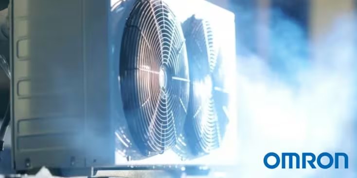 Close-up of an Omron cooling system featuring dual fans in a misty industrial setting. 