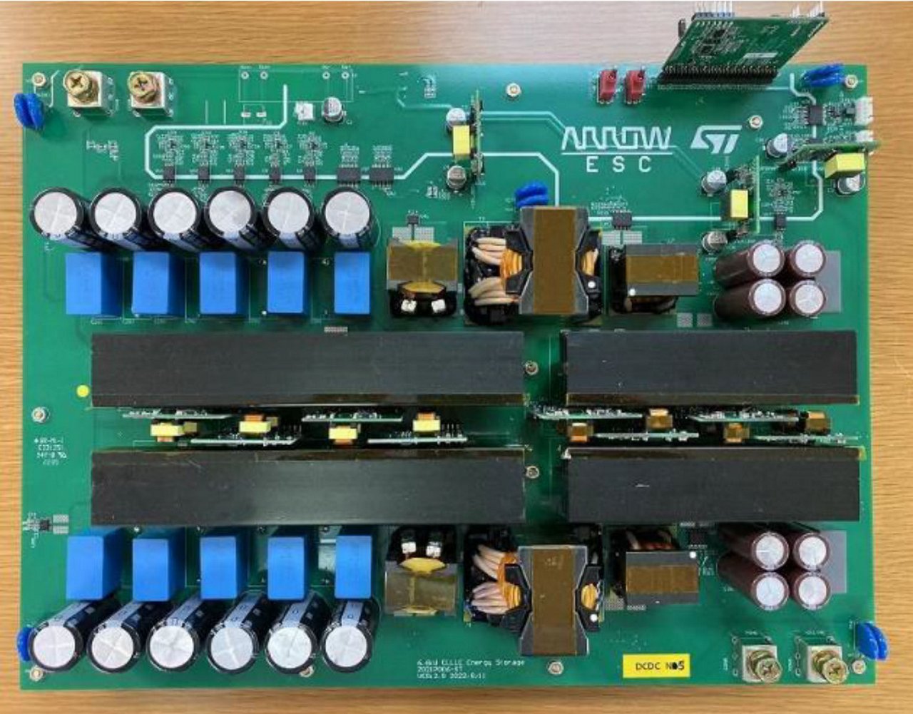 A detailed view of an electronic circuit board featuring multiple capacitors, modules, and connectors.