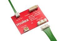 Red circuit board with Molex connectors and green cables, demonstrating a high-density interconnect system.