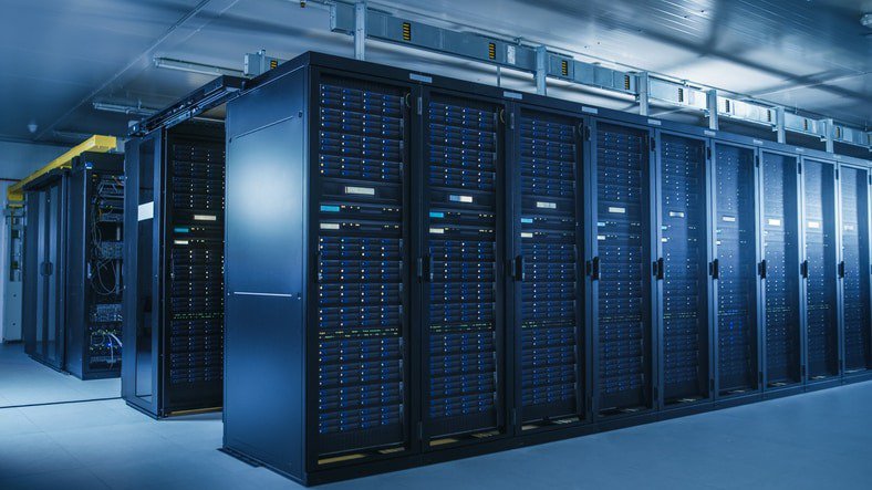 A spacious data center featuring rows of advanced server racks in a well-lit, industrial setting