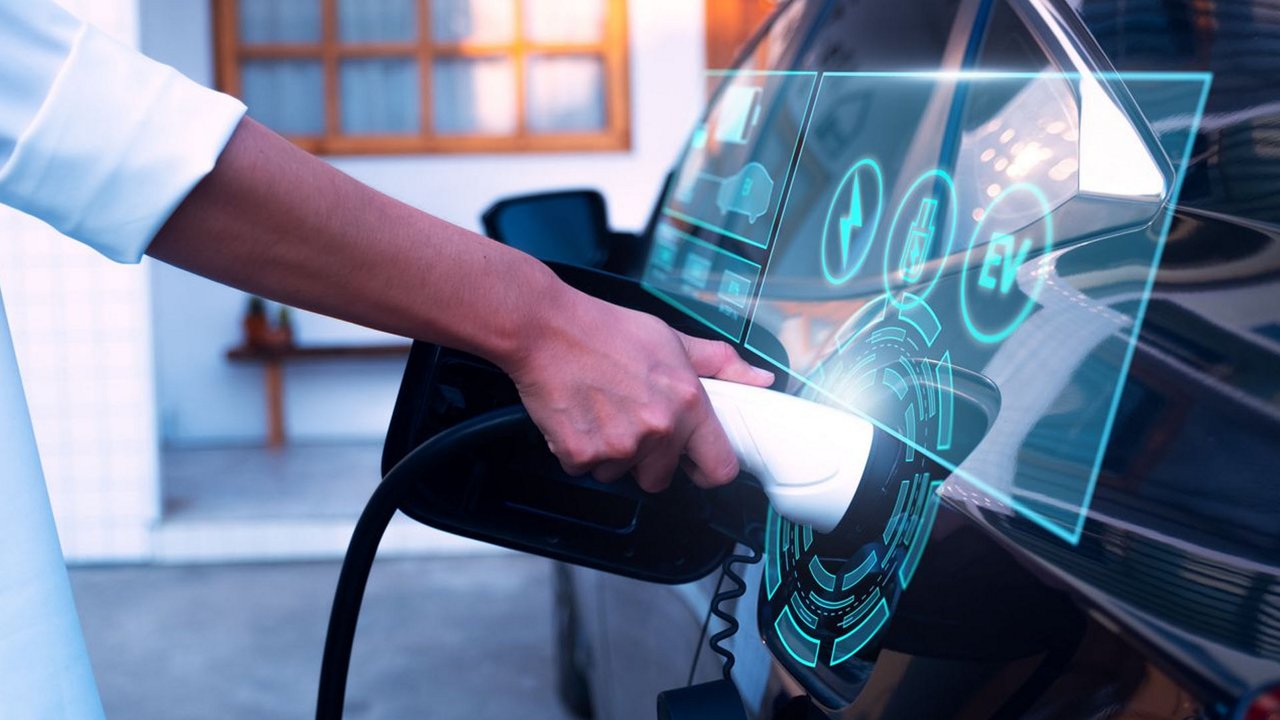 A close-up of an electric car being charged, featuring a futuristic digital interface overlay. 