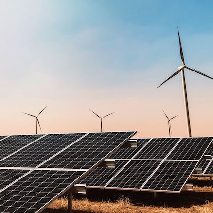 Clean energy concept. solar panel with wind turbine and blue sky