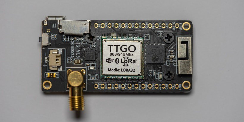 A TTGO LORA32 development board is shown in close-up, highlighting its electronic components and connectors.