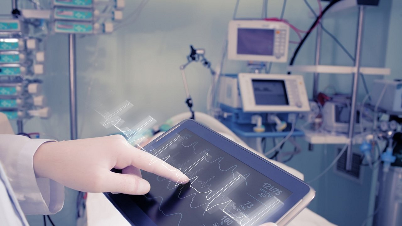 Doctor with advanced equipment in hospital ward.