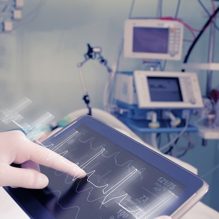 Doctor with advanced equipment in hospital ward.