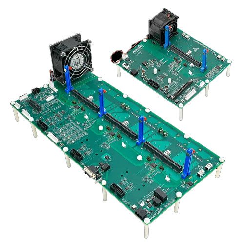 Two green circuit boards are displayed, featuring intricate electronic components and connectors. The boards are equipped with cooling fans and mounted on metallic stands. 